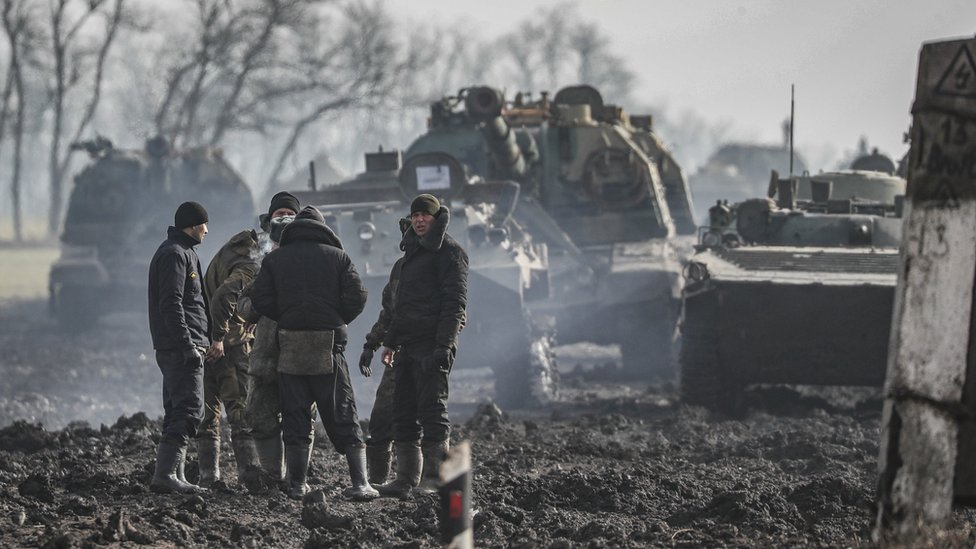 Russian servicemen and armoured vehicles stand on the road in the Rostov region of Russia